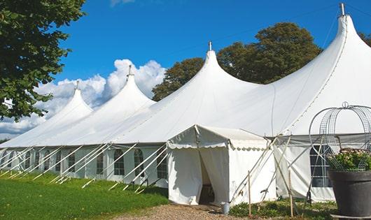 a line of portable restrooms in a shaded area, offering a comfortable experience for users in Eden